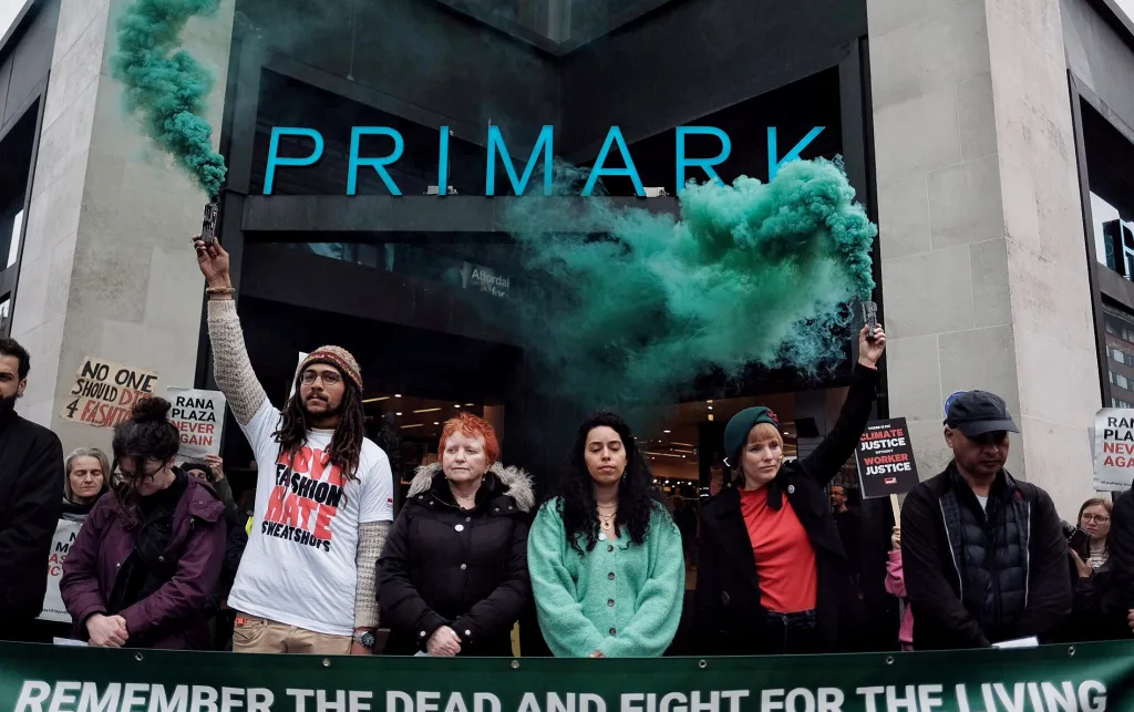 War on Want activists memorialise the workers that lost their lives at Rana Plaza, on a 10th anniversary walking tour around companies whose clothes were produced there. London, UK, 2023.  