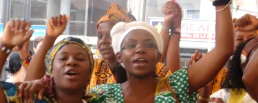 Francia Marquez and other Black women raise fists in the air. 