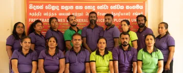 A group of people stand together and look at the camera